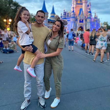 Mariazel Olle Casals with her huband and daughter at disney land.